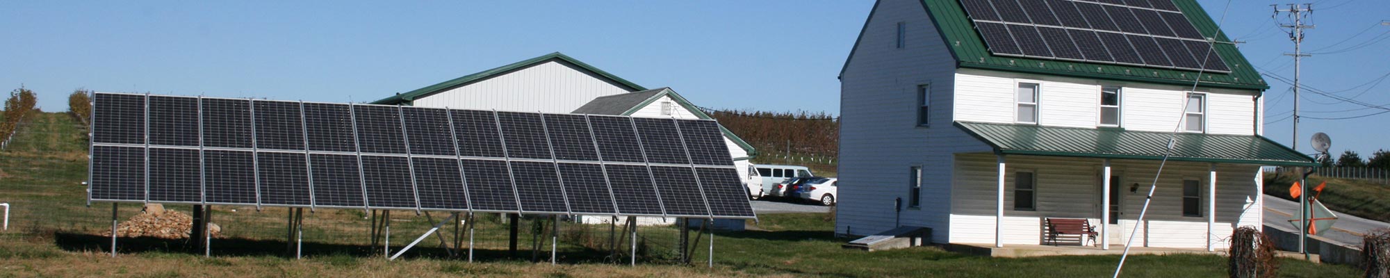 solar panels on a home's roof and on the side lawn